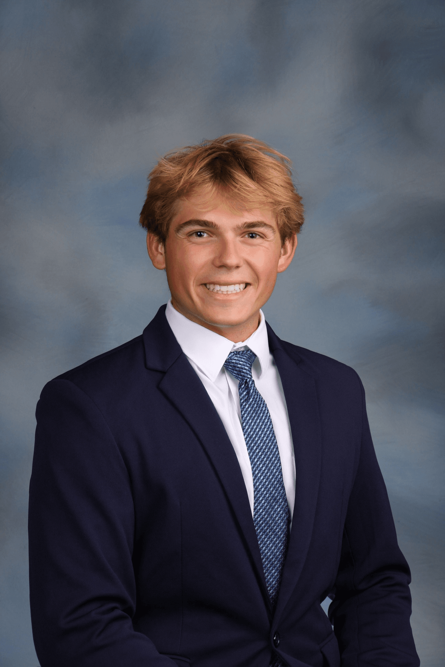 Luke Fournier in a suit and tie