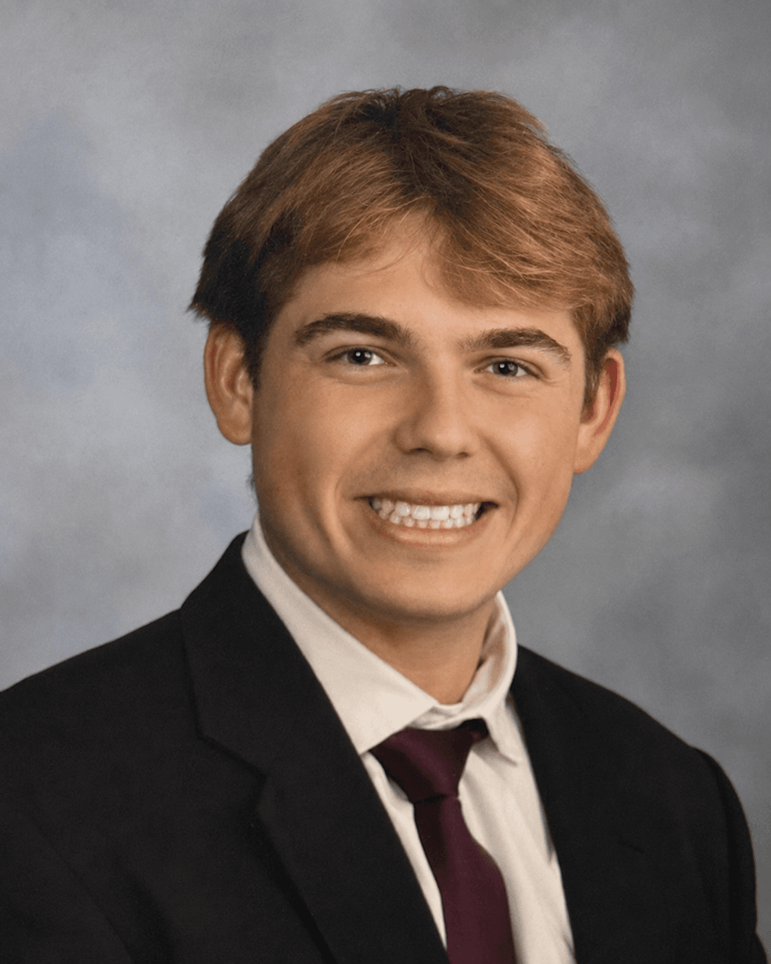 Luke Fournier in a suit and tie